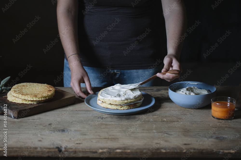 Crop hands decorating cake with cream Crop hands decorating cake with cream