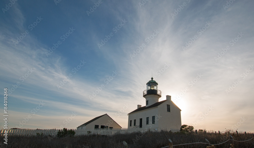 OLD POINT LOMA LIGHTHOUSE UNDER BLUE CIRRUS SUNSET CLOUDSCAPE AT POINT LOMA PENINSULA IN SAN DIEGO IN SOUTHERN CALIFORNIA UNITED STATES