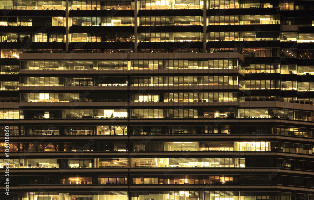 office building at night. Late night at work. Glass curtain wall office building office building at night. Late night at work. Glass curtain wall office building