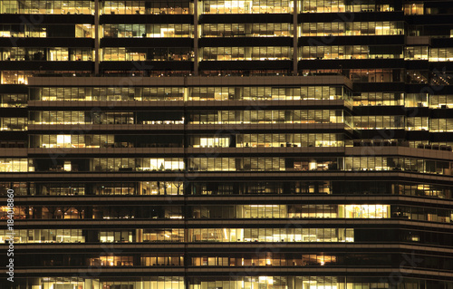 office building at night. Late night at work. Glass curtain wall office building