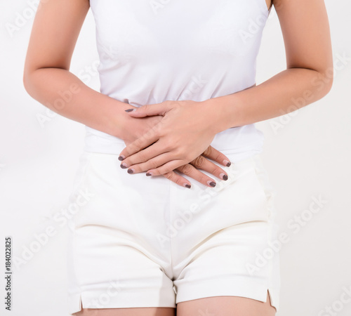 Wallpaper Mural Pain in stomach. Beautiful young Asian woman feeling strong abdominal pain.  Isolated on white background. Studio lighting. Concept for healthy and medical Torontodigital.ca