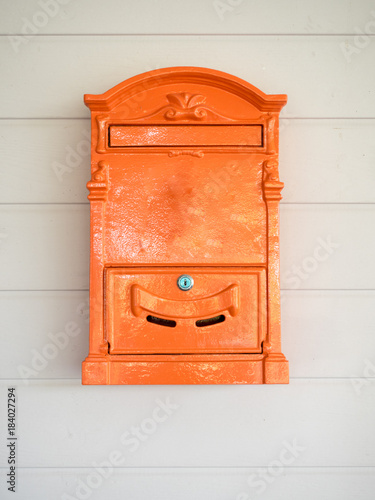 orange post box on wood background
