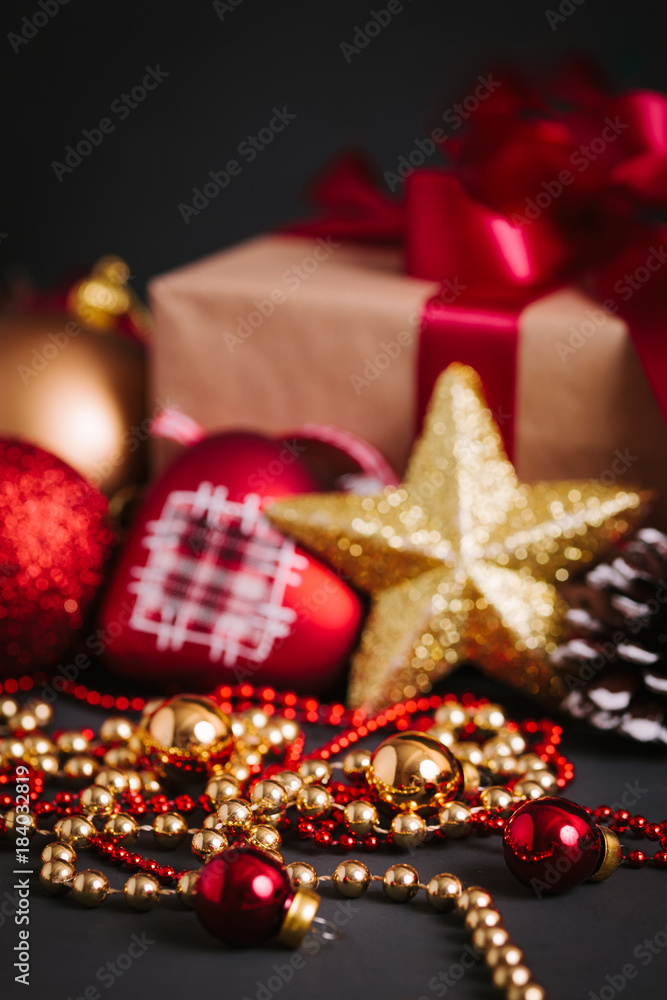 Composition with Christmas decorations and gift on black background Composition with Christmas decorations and gift on black background