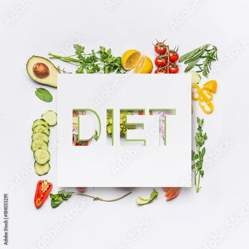 Fototapeta Naklejka Na Ścianę i Meble -  Various healthy salad vegetables ingredients and text diet on white desk background, top view.   Clean eating layout, vegetarian food and diet nutrition concept.
