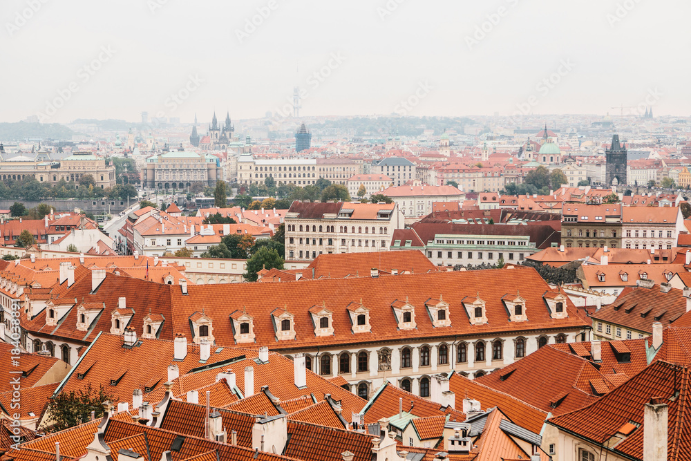 A view from above on the roofs of houses and beautiful architecture in Prague in the Czech Republic.