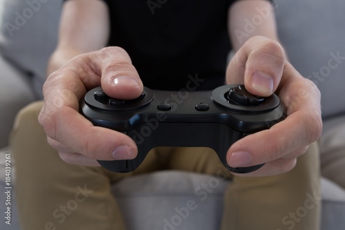 Man playing video game against white background © WavebreakMediaMicro