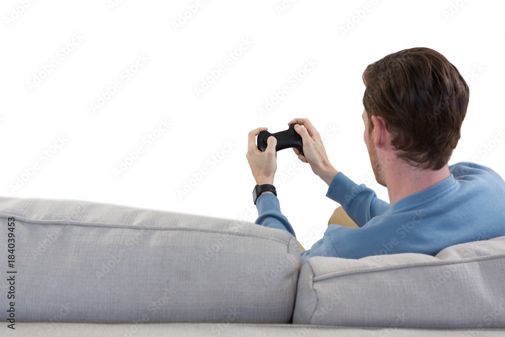 Fototapeta premium Man playing video game against white background