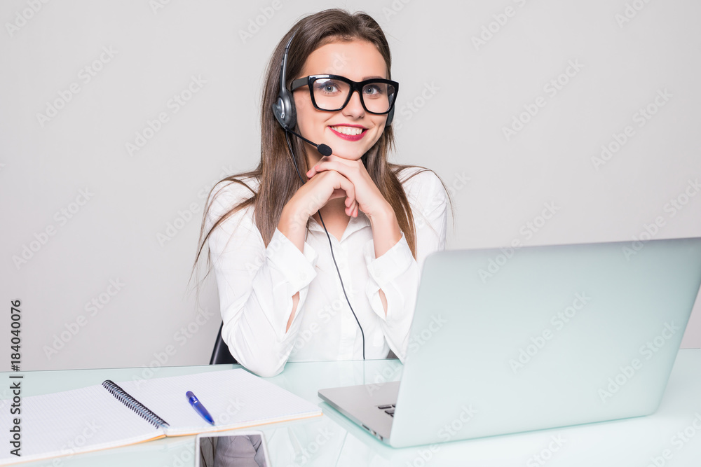 picture of smiling female helpline operator with headphones in office picture of smiling female helpline operator with headphones in office