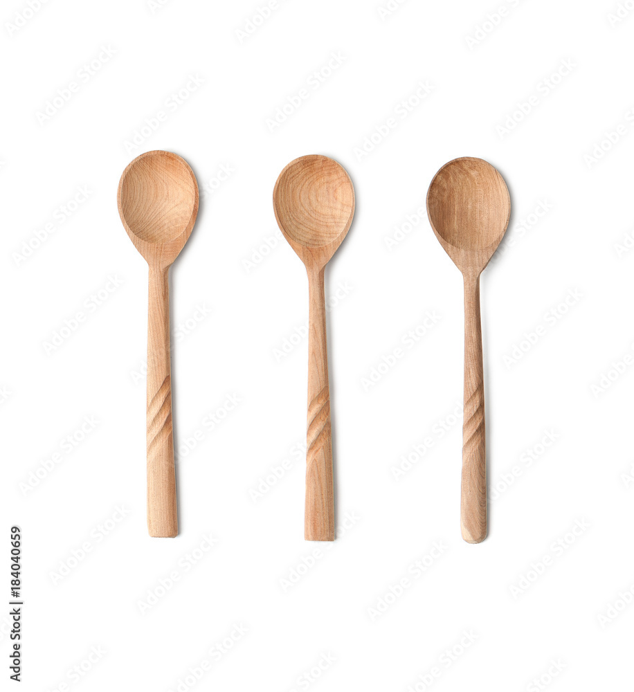 Three teaspoons of natural wood. Isolated on white background.. Three teaspoons of natural wood. Isolated on white background..
