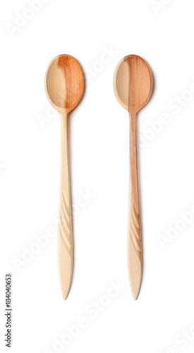 Two long teaspoons made of natural wood. Isolated on white background..