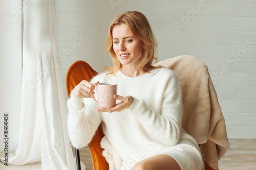 Cheerful nice woman drinking tea