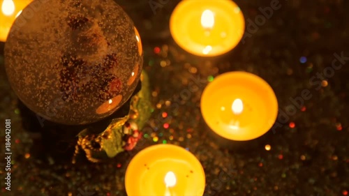 Christmas souvenir on a background of lighted candles and glitter photo