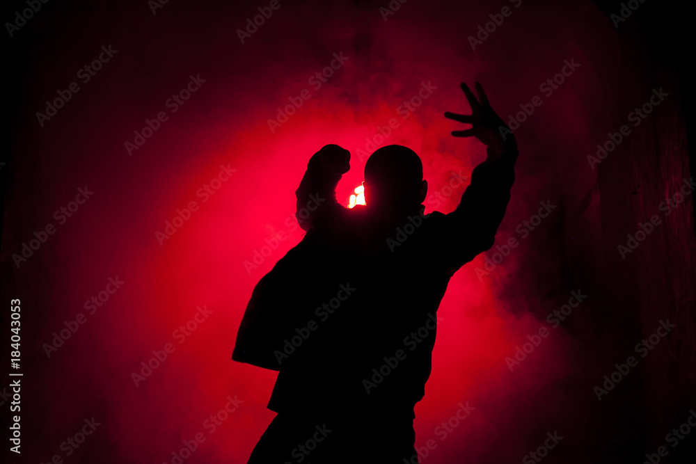 Silhouette of a dancer man in red light