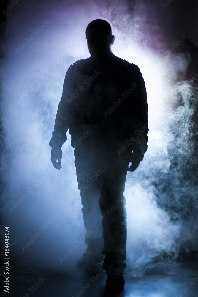 Silhouette of a man in fog light