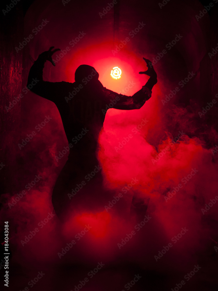 Silhouette of a dancer man in the red light
