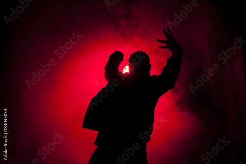 Silhouette of a dancer man in red light photo