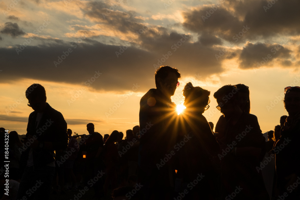 People at festival during summer sunset 