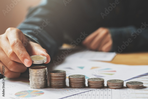 female hand stack coins to show for business accounting concept