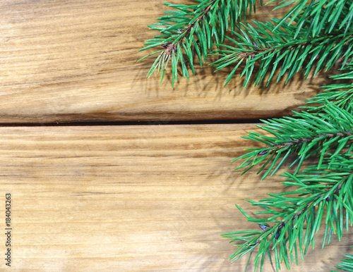 Christmas holiday background. Fir branches with space for text on a wooden background. 