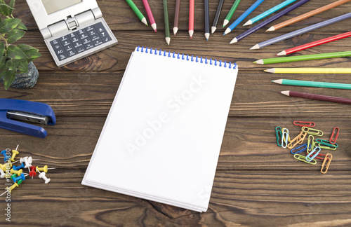notebook, stationery on a wooden background