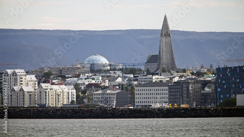 The waterfront and Hallgr’mskirkja (Church of Iceland) parish church seen from the approch to Reykjav’k harbour, Iceland.