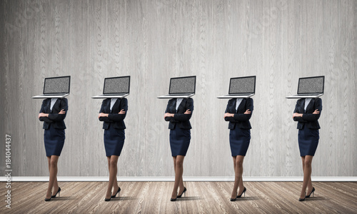 Business women with laptops instead of head.