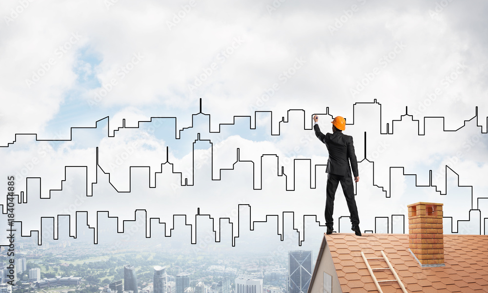 Man architect draw silhouette of modern city on blue sky. Mixed media Man architect draw silhouette of modern city on blue sky. Mixed media