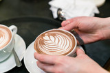 latte art coffee  on barista hands

