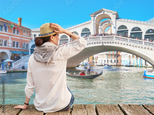 Woman traveler in hat enjoying summer time, Rialto Bridge on the background, Venice © acnaleksy