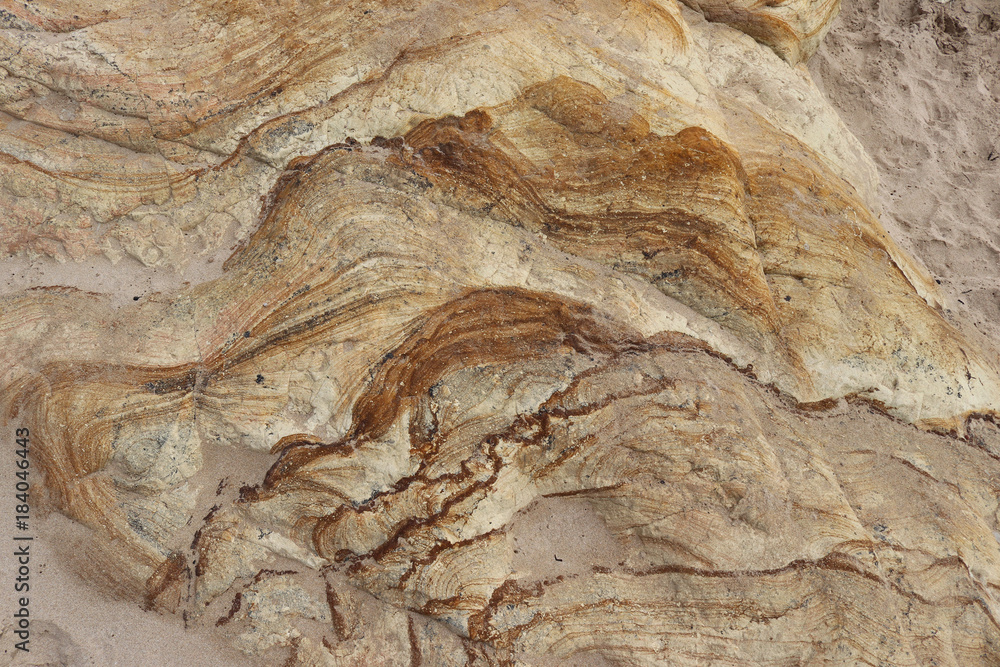 Naklejka premium patterned and textured rock formation on a beach