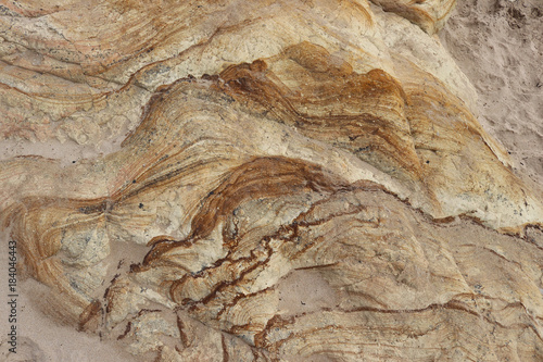 patterned and textured rock formation on a beach