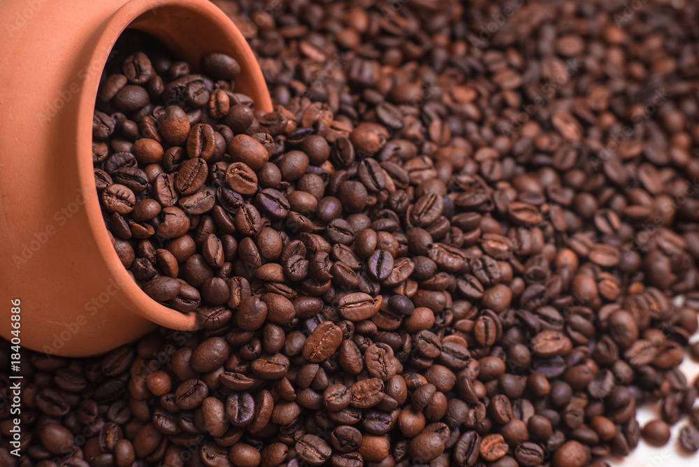 Coffee beans with clay pot background. Place for text or design. Coffee beans with clay pot background. Place for text or design.
