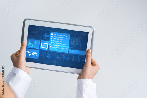 Close of female doctor hands working with tablet pc computer