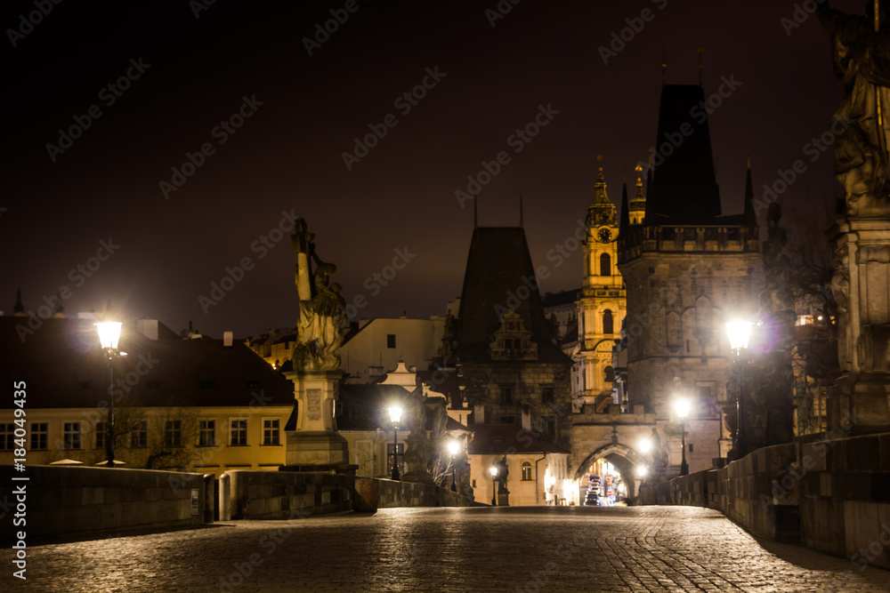 Fototapeta premium Charles bridge in Prague with lanterns at night