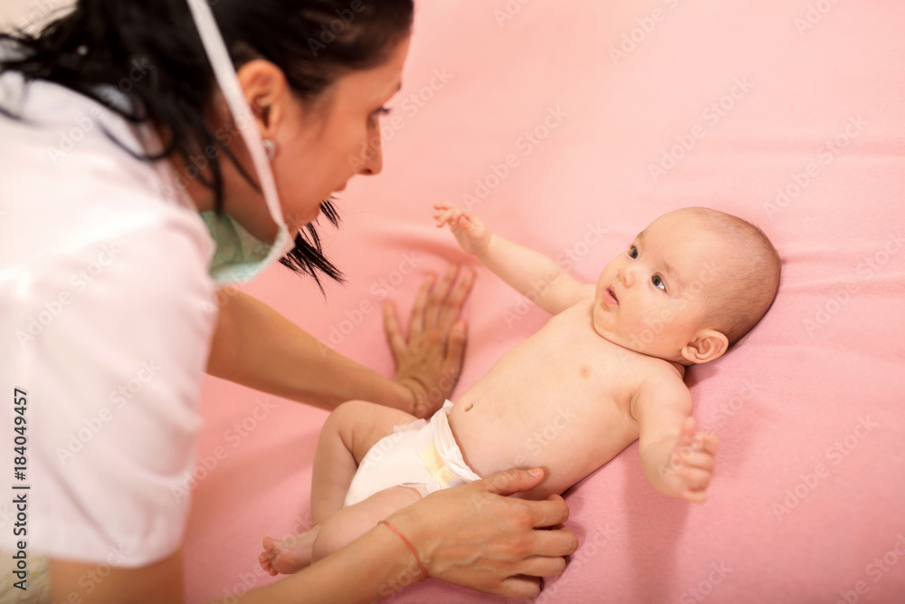 Doctor examining little baby in clinic. Baby health concept Doctor examining little baby in clinic. Baby health concept