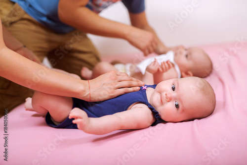Newborn babies - twin sisters together.Changing diapers