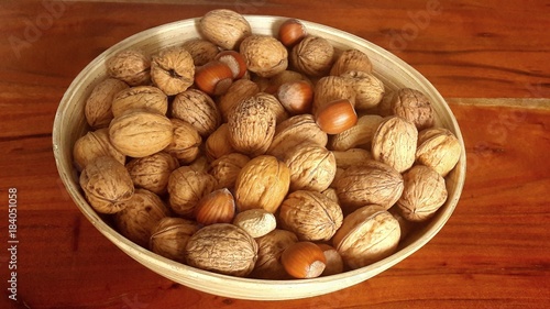 walnuts and hazelnuts in a wooden bowl