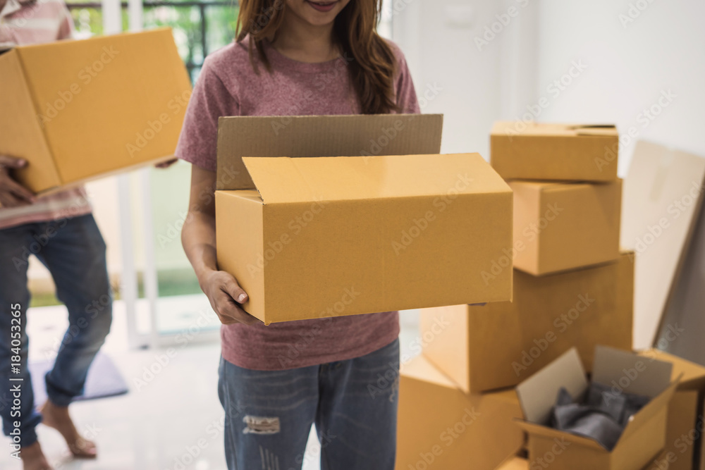 Young couple carrying cardboard boxes Young couple carrying cardboard boxes