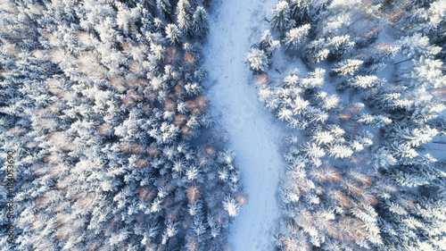 top view of snowy winter forest and road