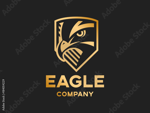 Head of the eagle on the shield - golden logo, mark, emblem on a dark background