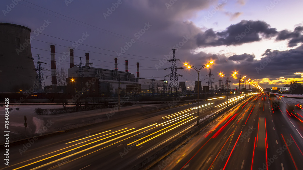 night traffic on urban thoroughfare along industrial zone