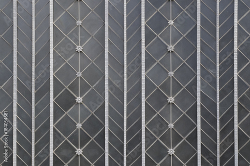 Background image of steel geometric pattern over grey glass (Madrid, Atocha train station).