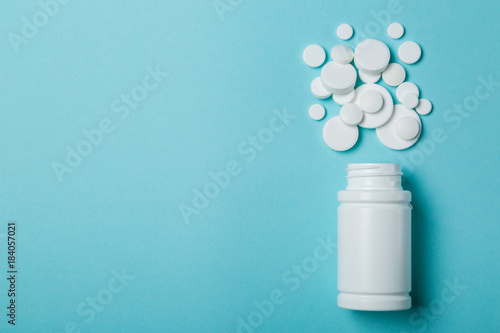 Medical concept - different shape white pills on blue background