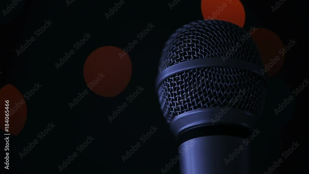 Audio microphone in karaoke bar with festive bokeh light background Audio microphone in karaoke bar with festive bokeh light background