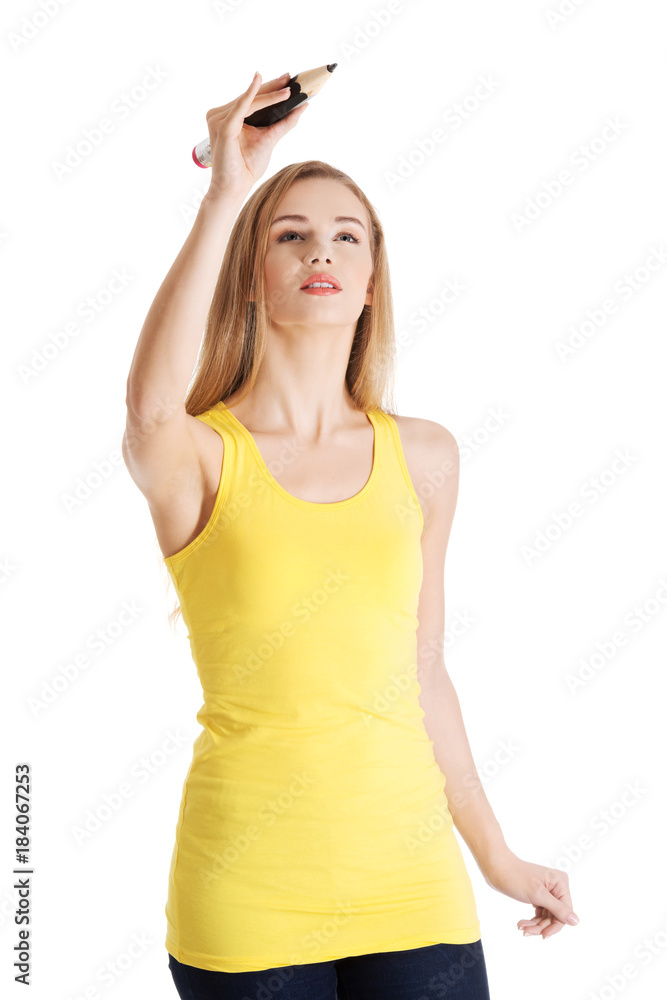 Beautiful caucasian casual woman is writing on copy space. Beautiful caucasian casual woman is writing on copy space.