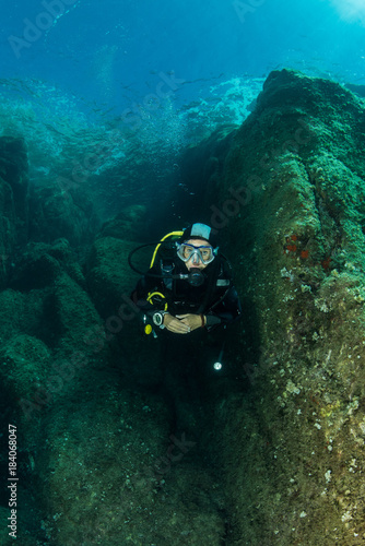 Wallpaper Mural woman scuba diving over rocks in the Mediterranean Sea Torontodigital.ca