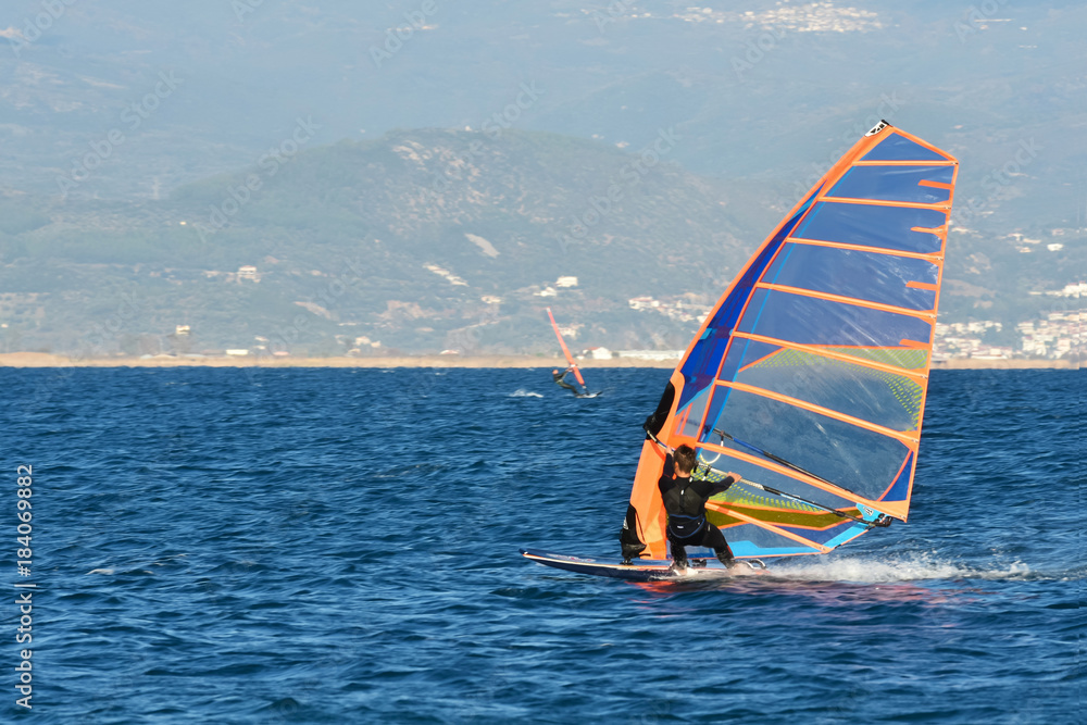 Naklejka premium Man Windsurfing Sea Beach Winter Sport