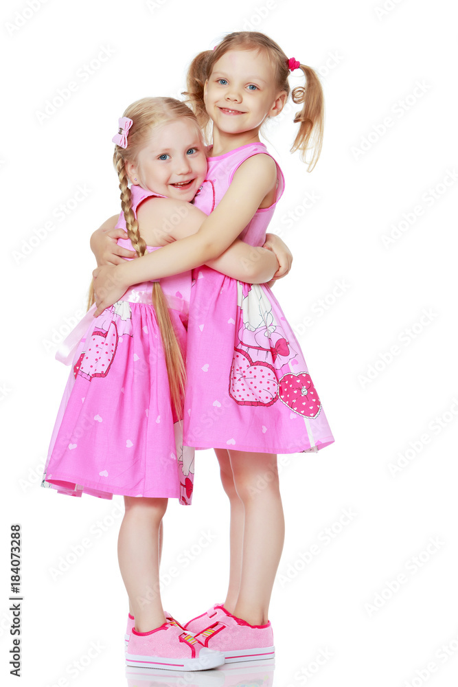 Two little girls hug. Two little girls hug.