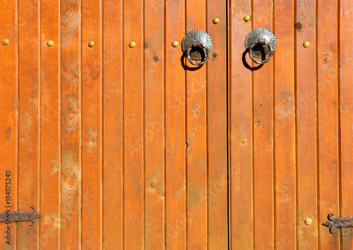 old wooden doors in the old stone building for your design © drutska