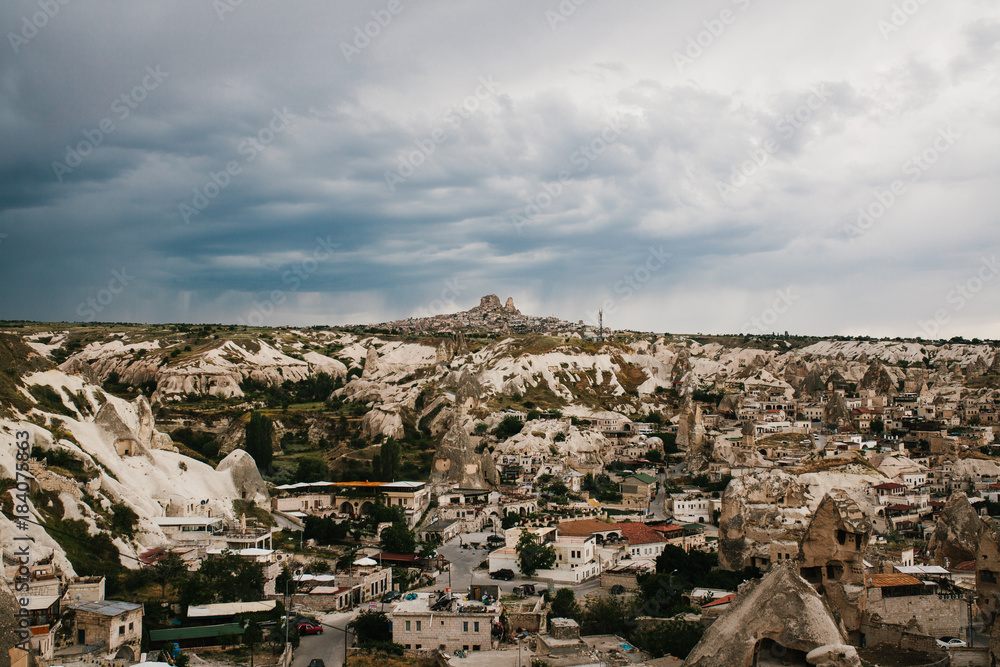 Top view. A small authentic city called Goreme in Cappadocia in Turkey in the evening. Dramatic night sky.